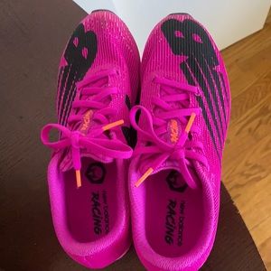New Balance size. Pinkish purple sneakers with orange detail. Very lightweight.